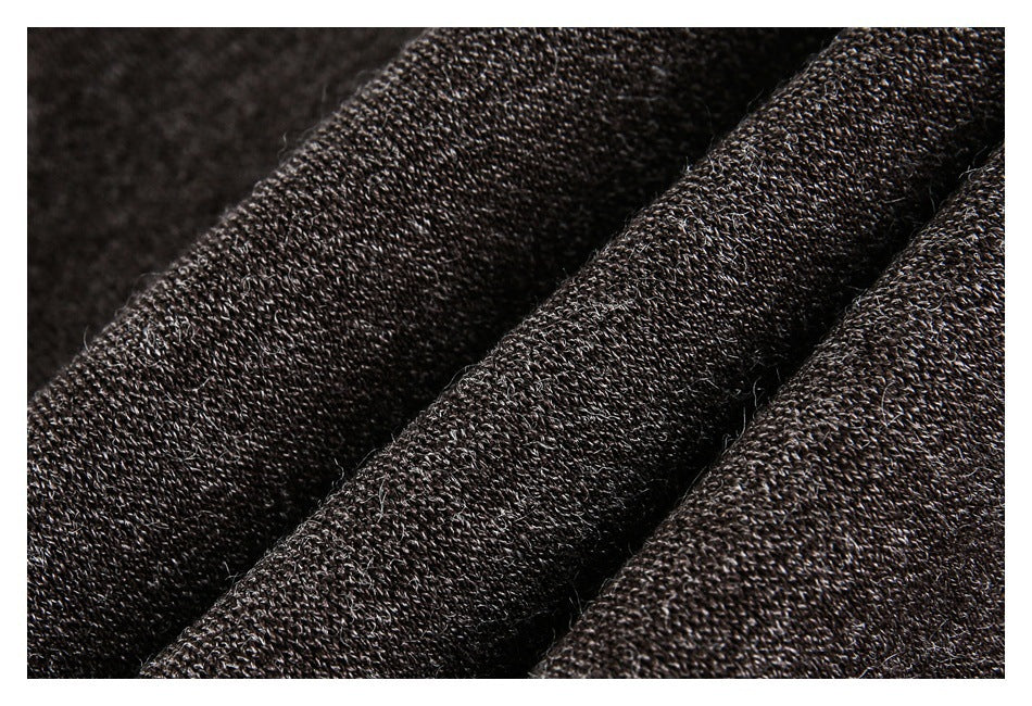Close-up of dark brown textured fabric arranged in soft folds.