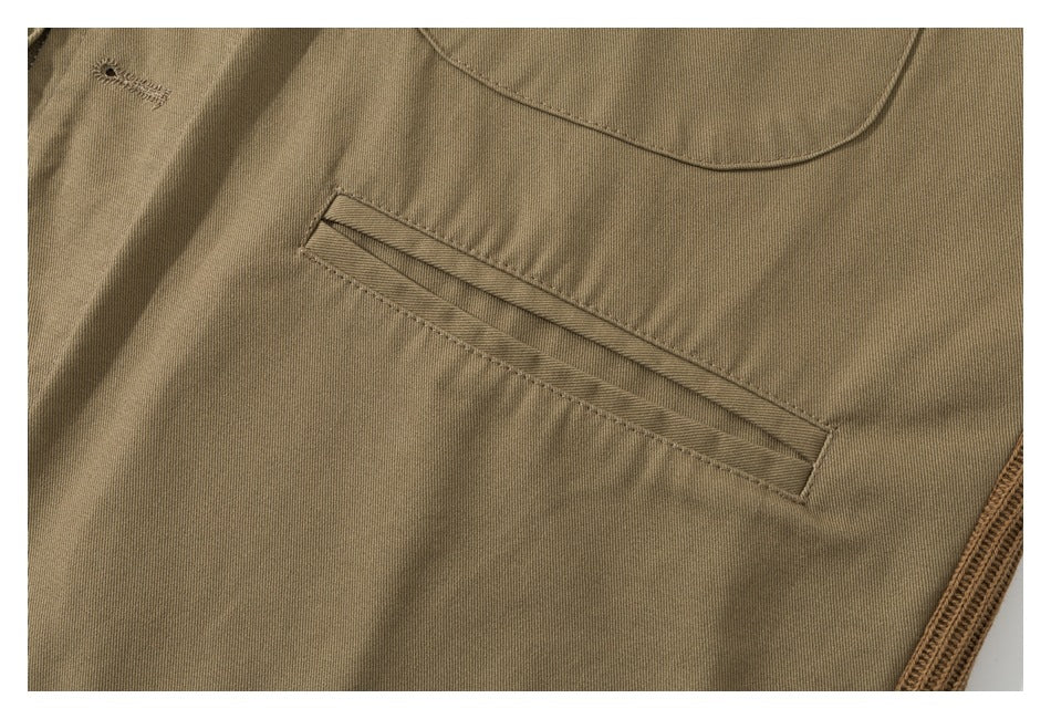 Close-up of a narrow welt pocket and stitching on the tan garment.