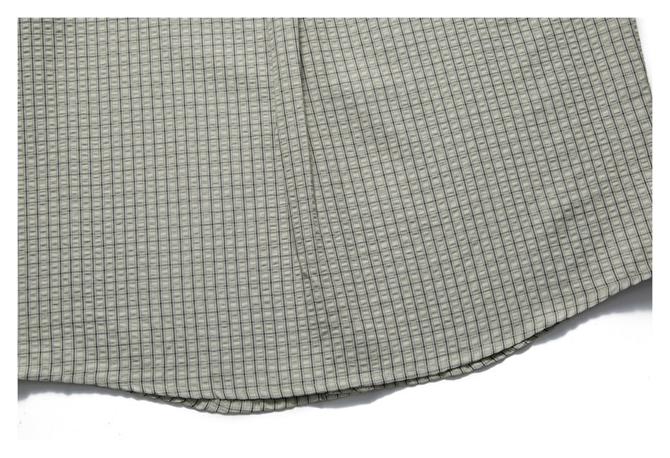 Cropped view of the checked shirt's lower back and curved hem.
