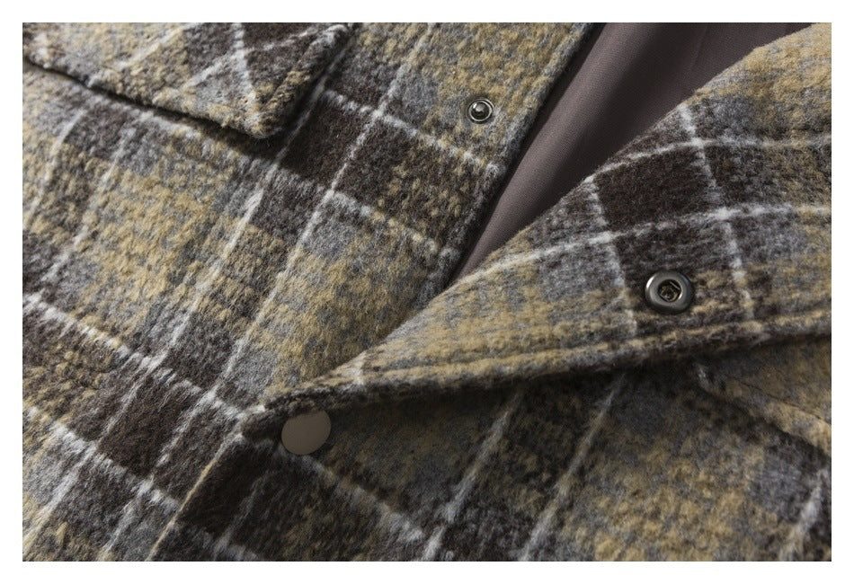 Close-up of the plaid jacket's snap-button front, open to show its dark lining.