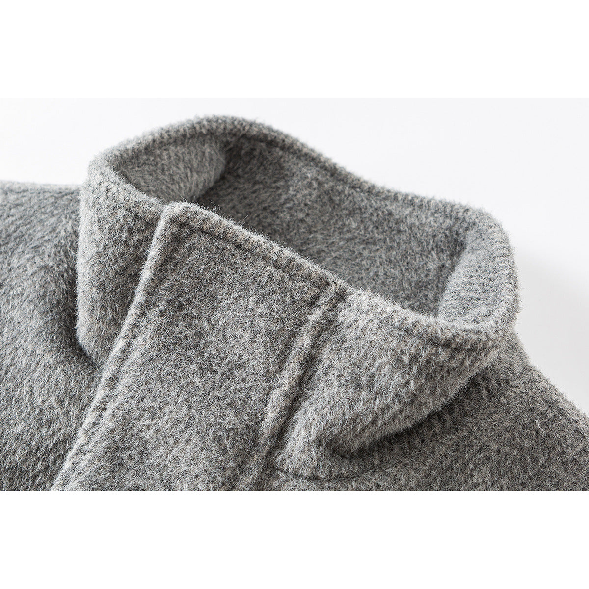 Close-up of a gray jacket's raised collar and textured fabric.