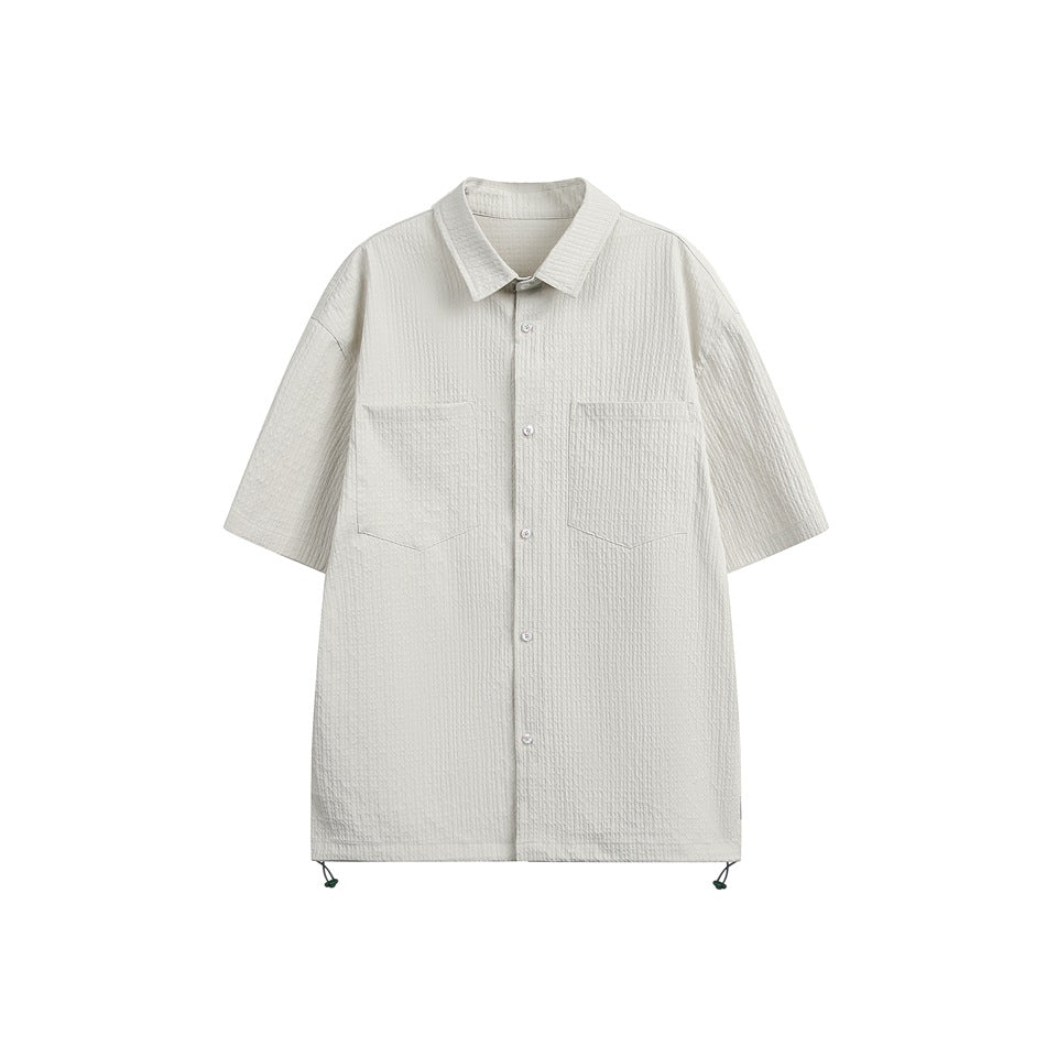 Light grayish-white short-sleeve textured button-up shirt with two chest pockets and hem drawcords, flat front view