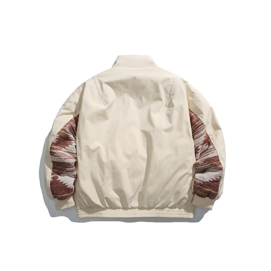 Back view of an ivory jacket with burgundy and cream patterned sleeve panels and a gathered hem.