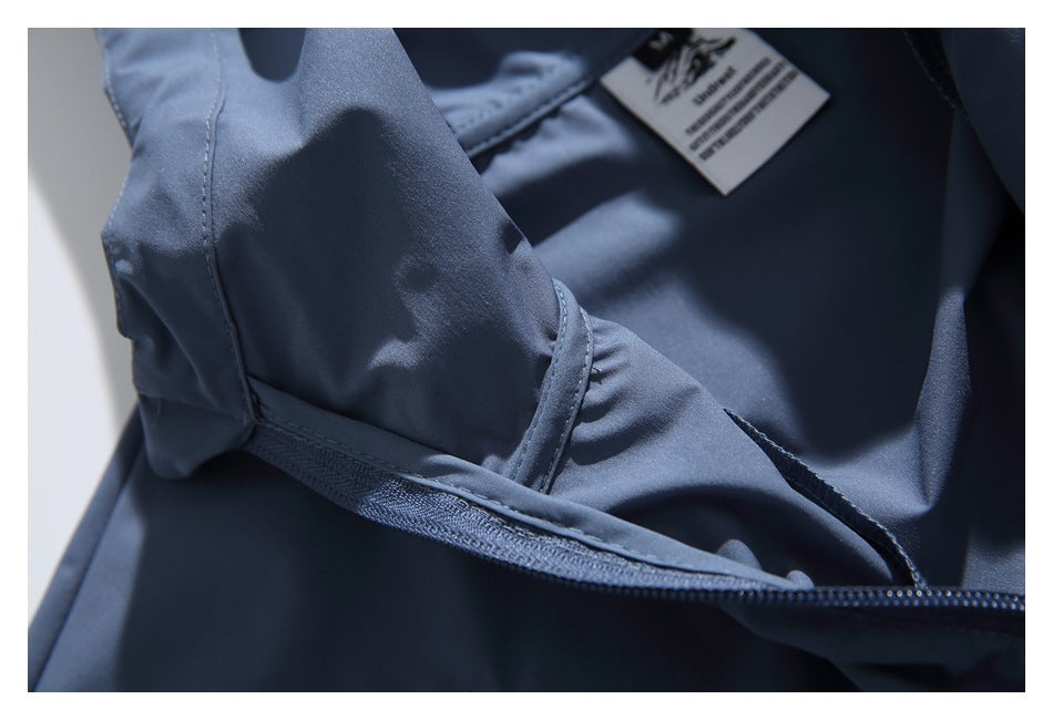 Close-up of a blue garment's interior zipper, stitching, and attached label.