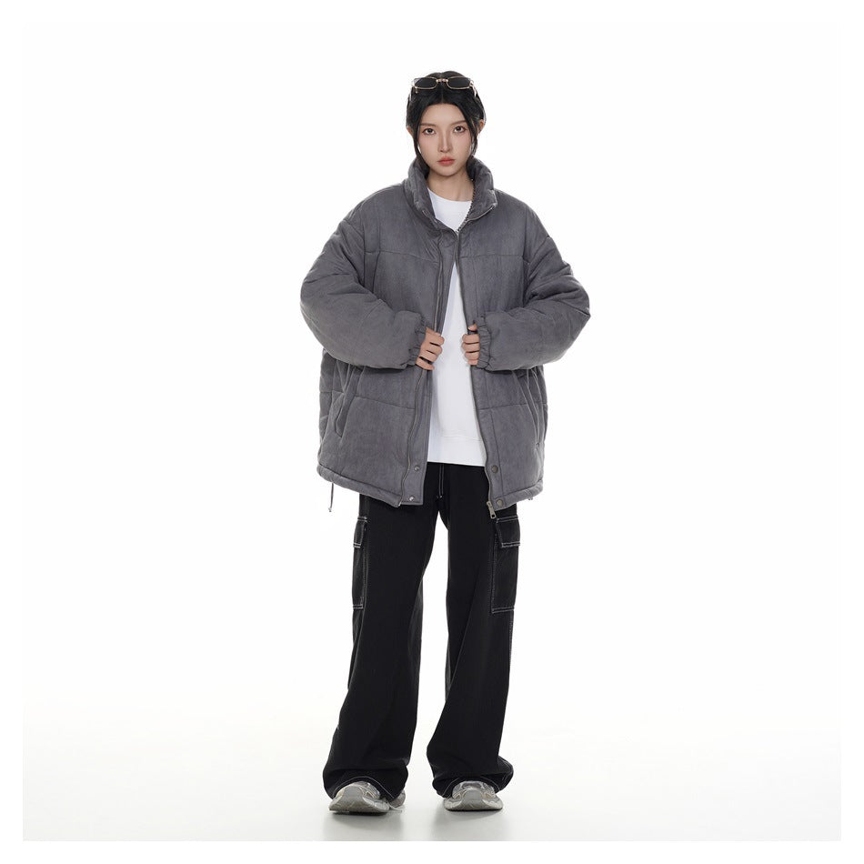 Model wearing an oversized charcoal-gray quilted jacket with a stand collar, shown from the front.