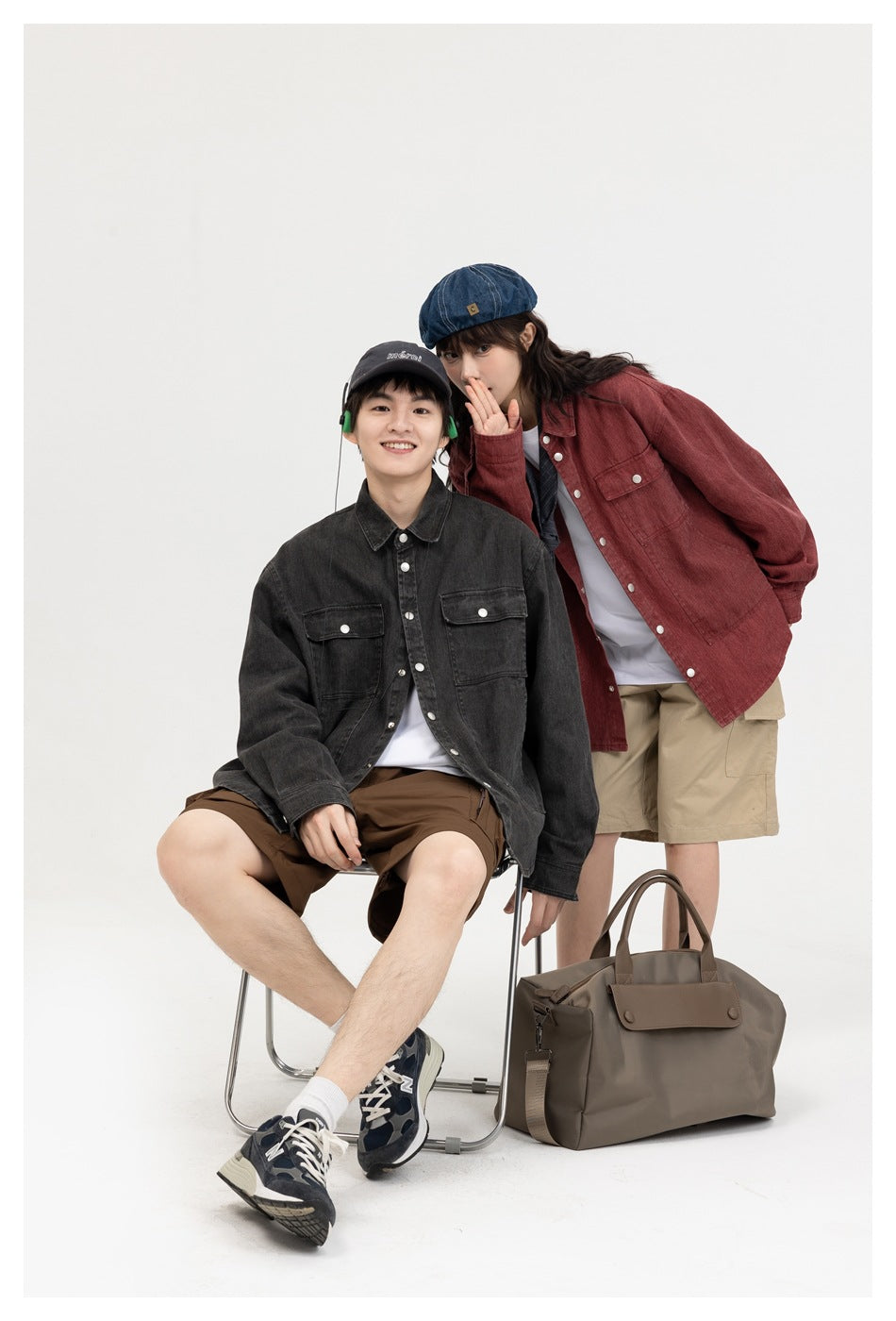 Two models pose in charcoal and muted red utility overshirts with button fronts and chest pockets.