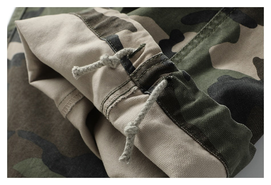 Close-up of camouflage pants fabric, stitched seams, and knotted drawcords.