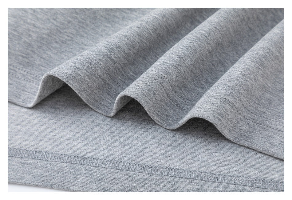 Close-up of heather gray knit fabric folded to show a stitched hem.