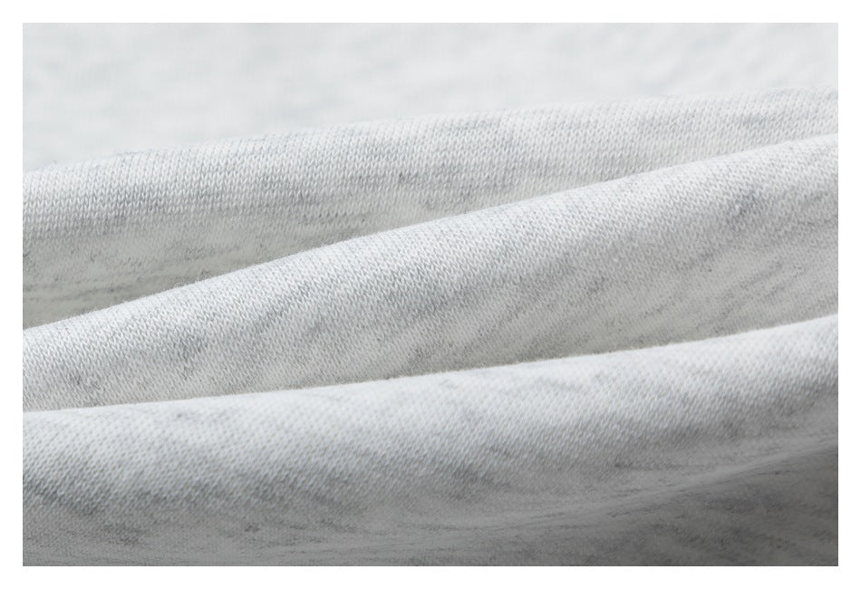 Macro view of light gray heathered knit fabric folded to show its texture.