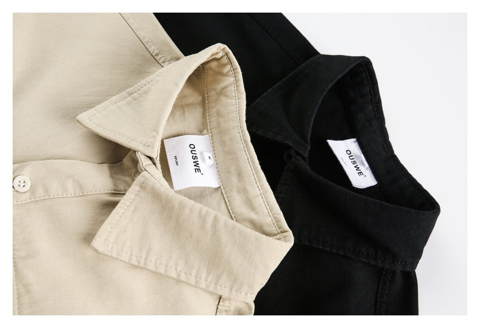 Close-up of beige and black shirt collars with sewn-in white OUSWE labels.