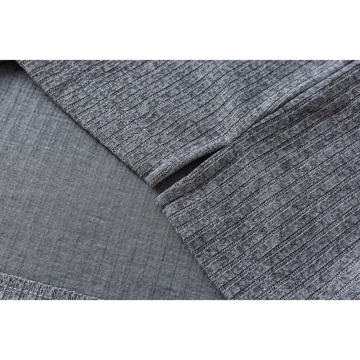Close-up of a gray ribbed shirt's fabric and small side hem slit.