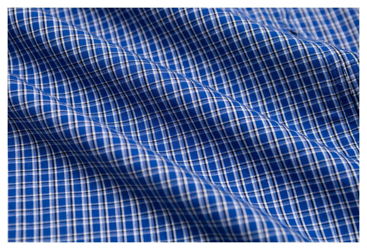 Close-up of blue plaid fabric showing its checked pattern and folds.