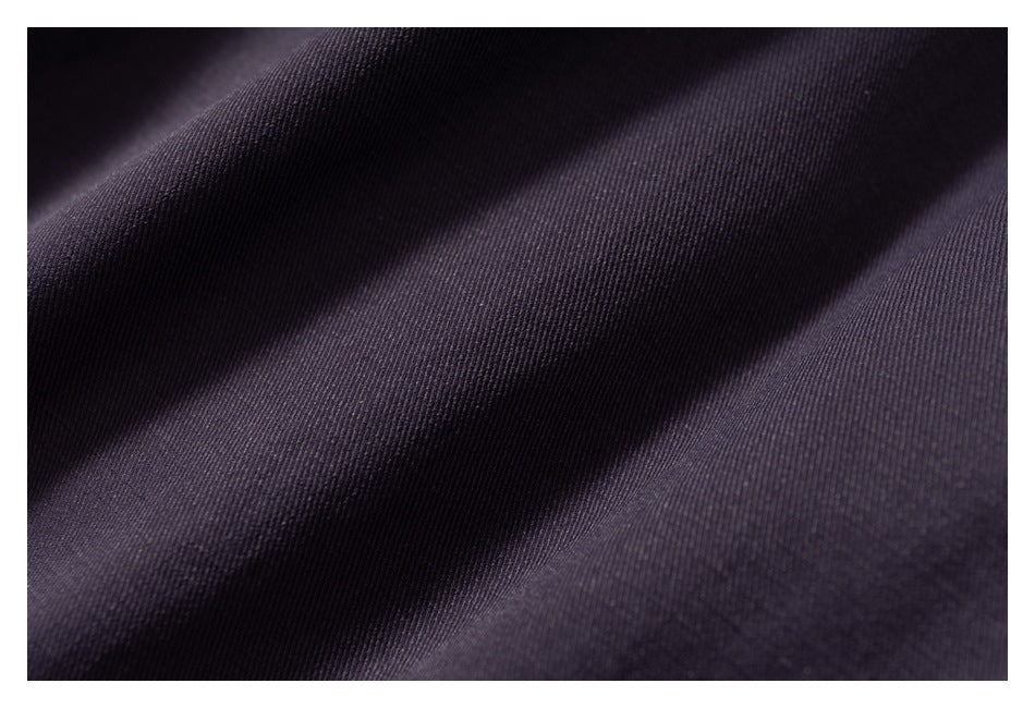Close-up showing the fine texture and folds of dark plum fabric.
