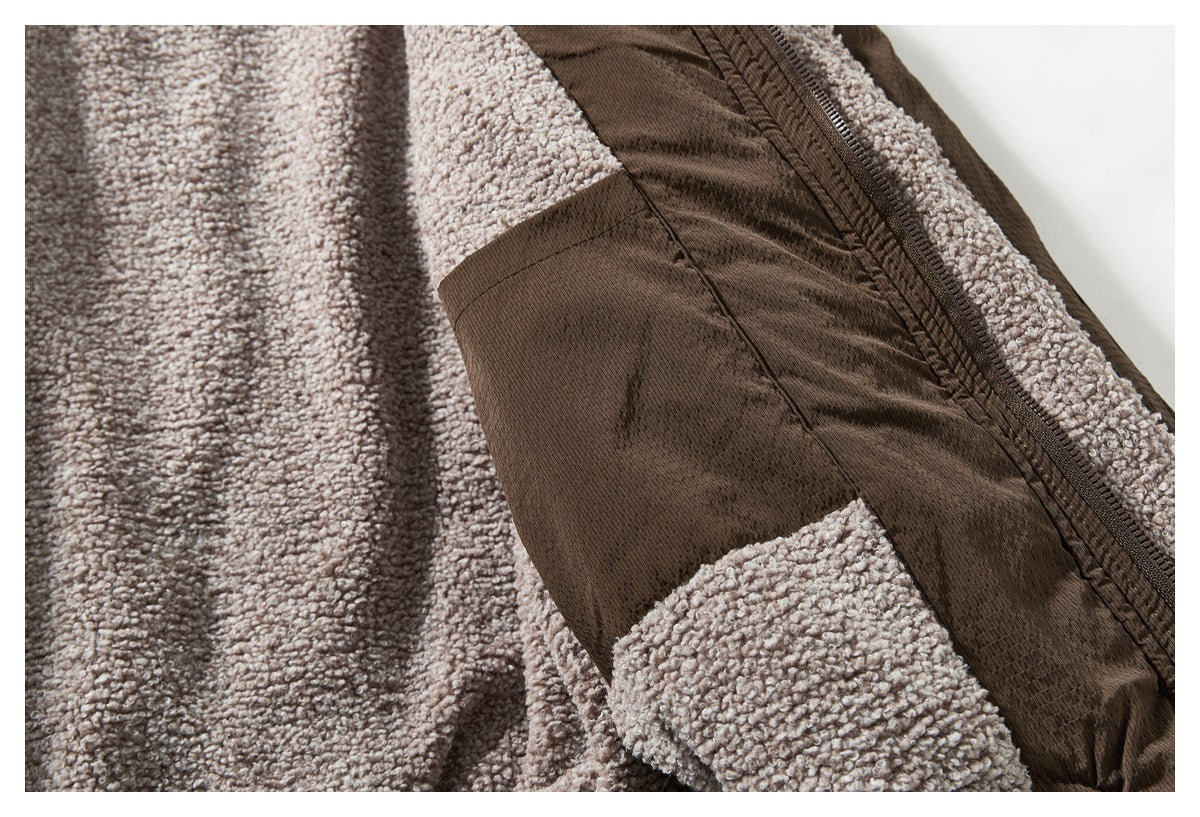 Close-up of the jacket's light taupe textured lining, brown panel, and zipper.