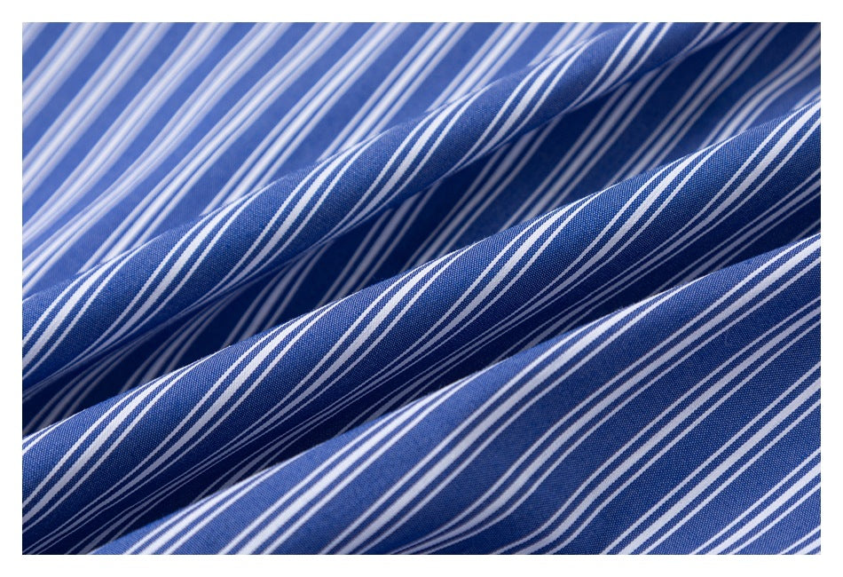 Macro view of blue fabric with narrow white vertical stripes.