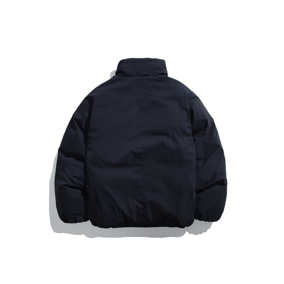 Back view of a dark navy jacket with a high collar, long sleeves and a plain body.
