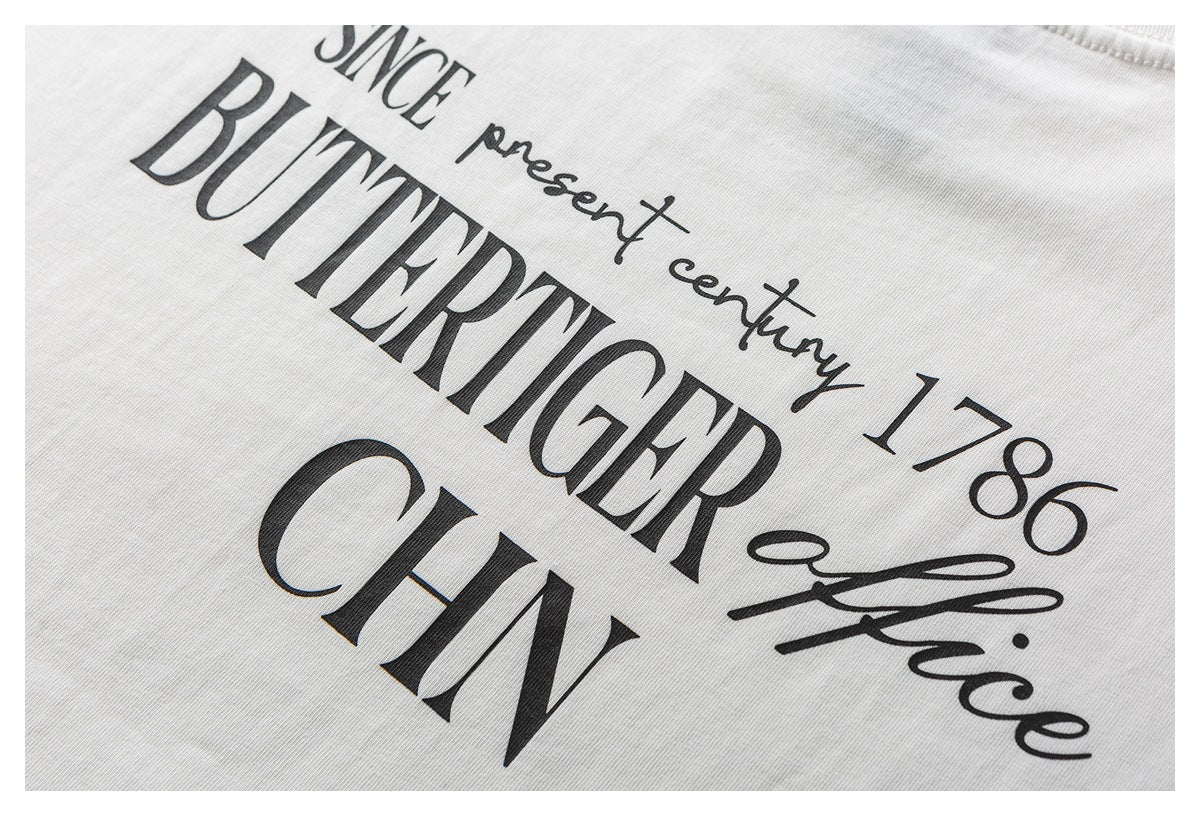 Close-up of a white garment with a large black English text print, including “BUTTERTIGER” and “CHN.”