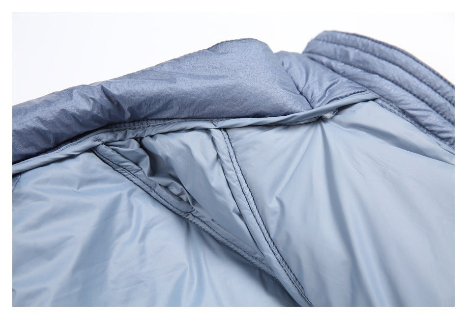 Close-up of light blue padded fabric showing folded construction, seams, and darker blue edging.