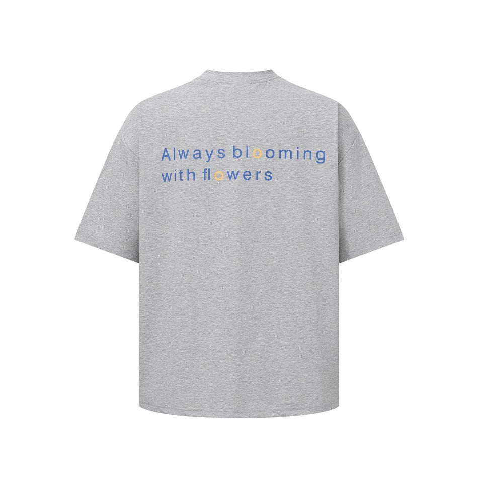 Heather gray short-sleeve T-shirt back with blue 'Always blooming with flowers' print and yellow accent letters