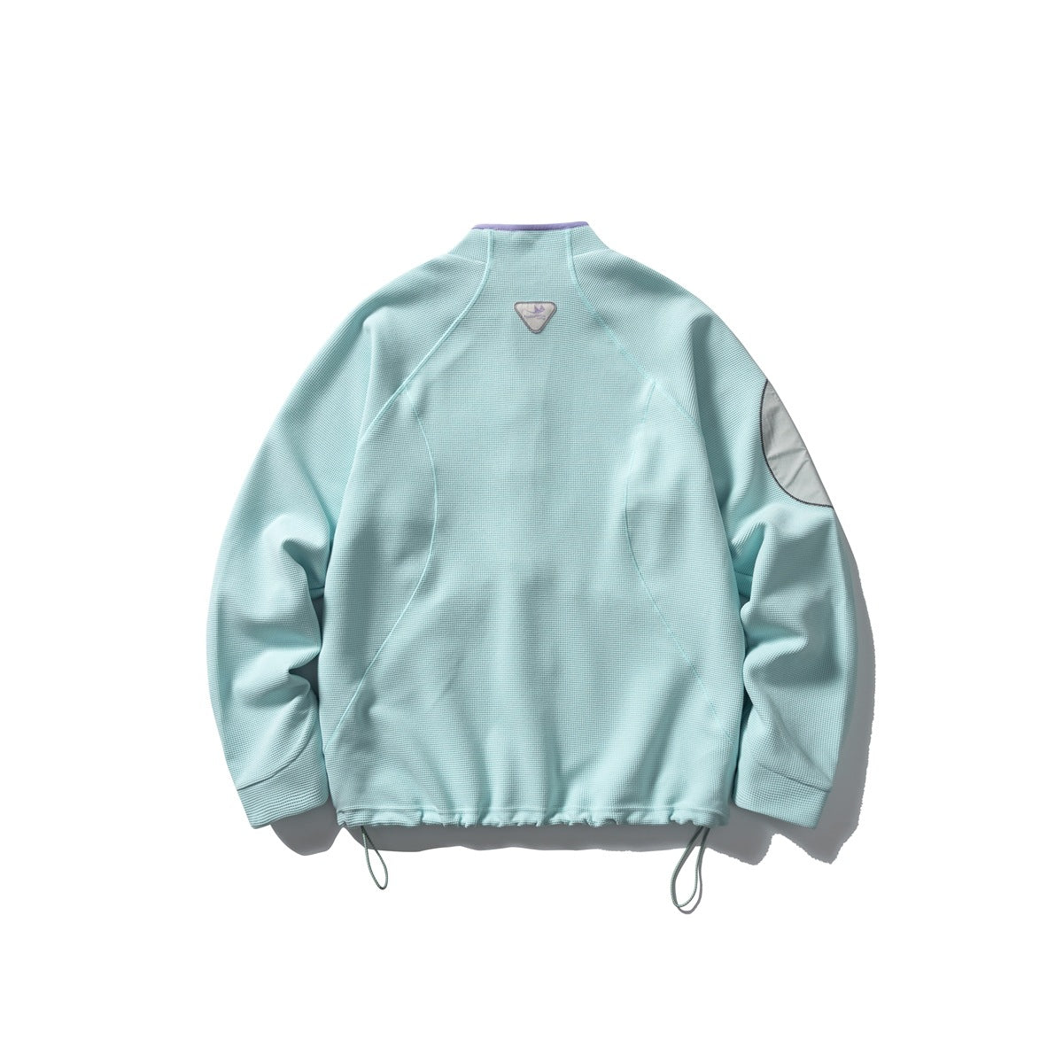 Back view of a pale aqua jacket with a stand collar, curved seams, a sleeve patch and adjustable hem cords.