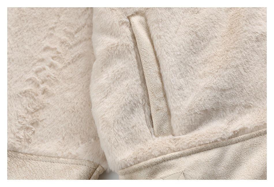 Close-up of a vertical pocket opening and textured panels on an ivory faux-fur jacket.