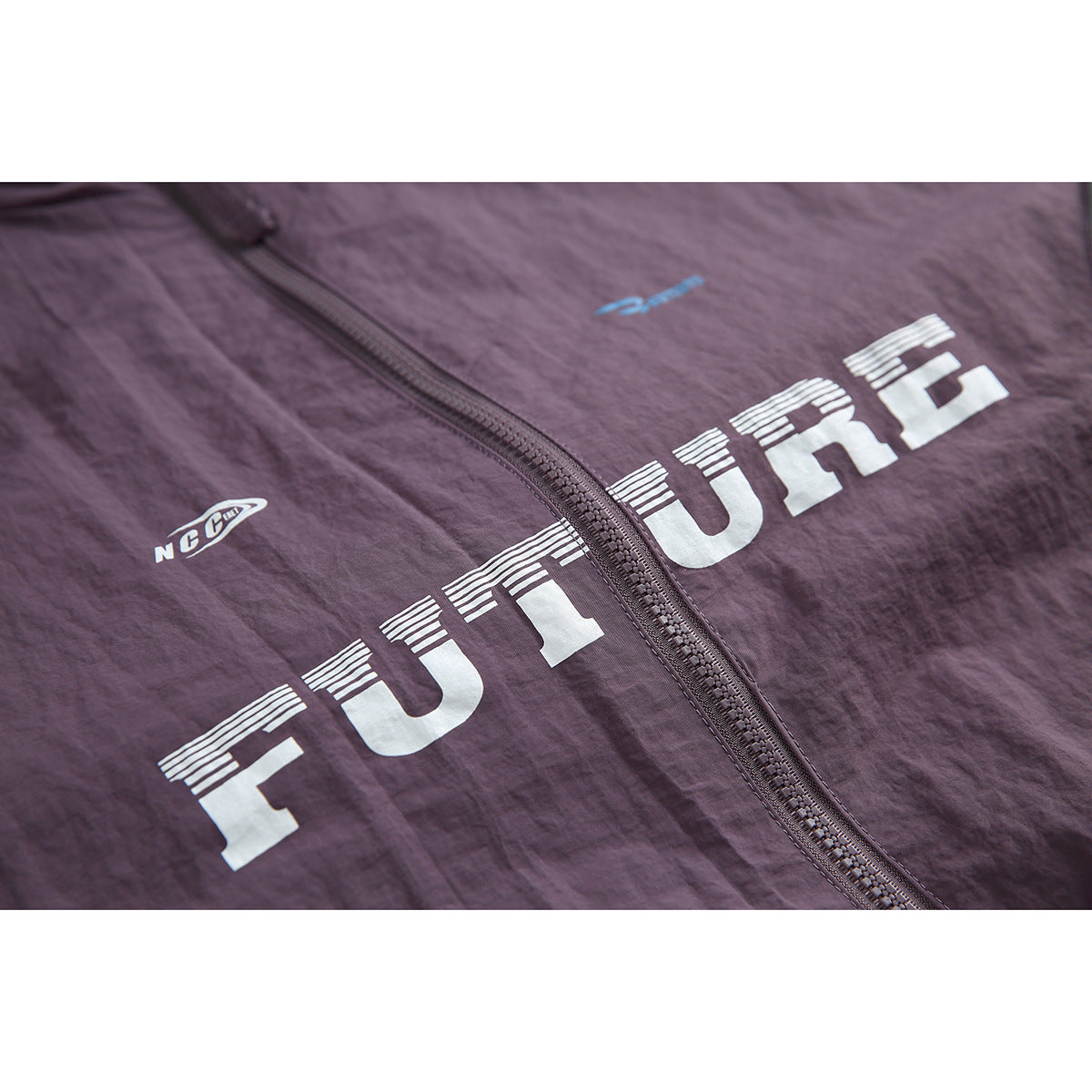 Close-up of the plum jacket's front zipper and large white FUTURE lettering.