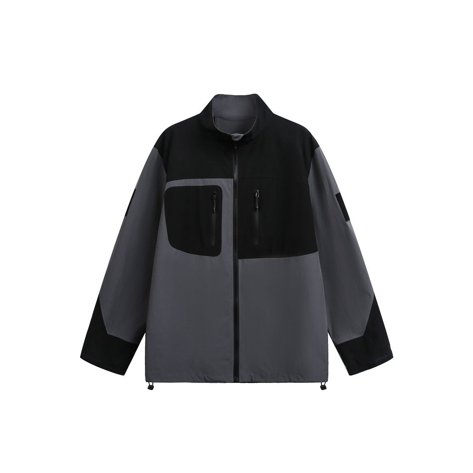Black and gray color-block zip jacket with stand collar, chest zip pockets and hem drawstring toggles, flat front view