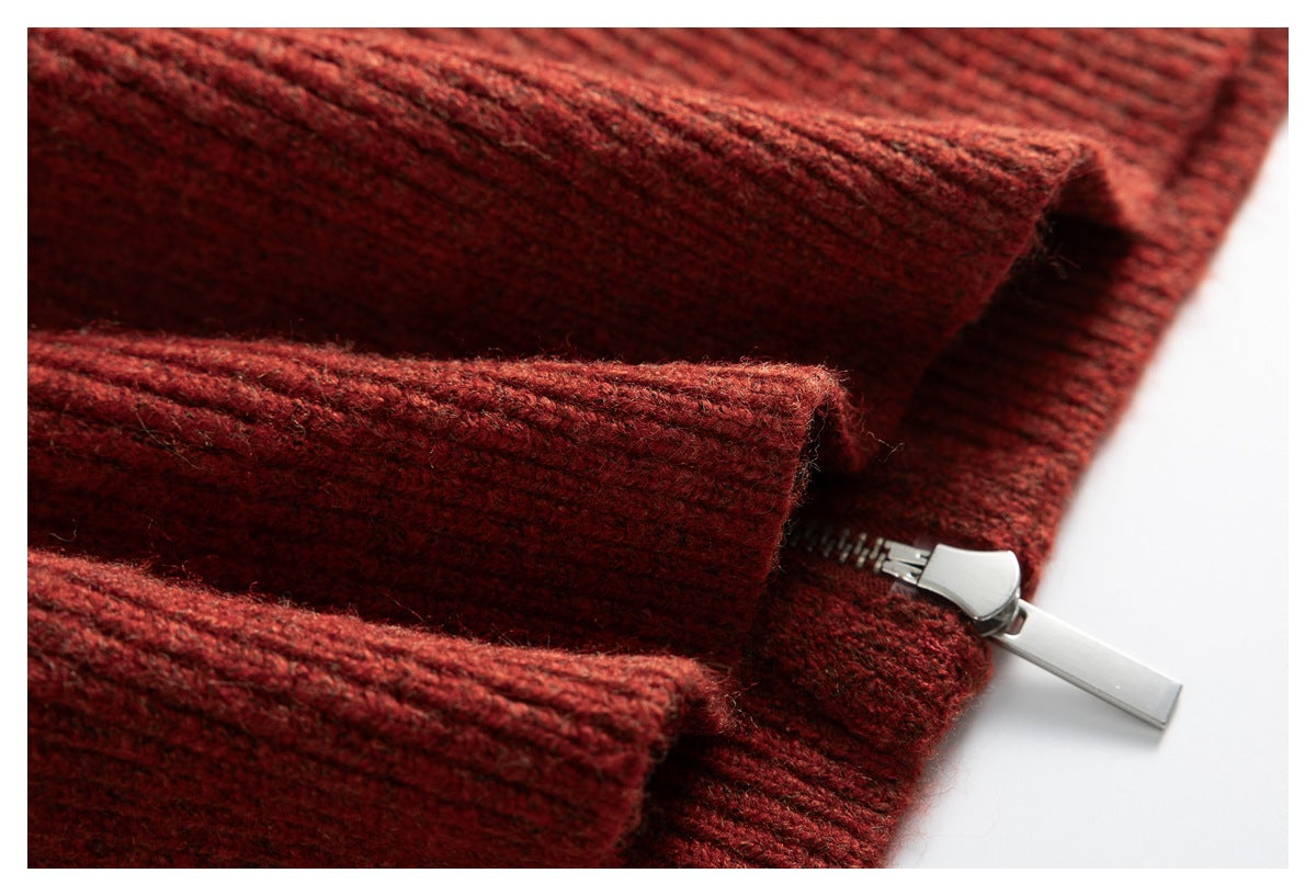 Close-up of a silver zipper beside the rust-red rib-knit collar.
