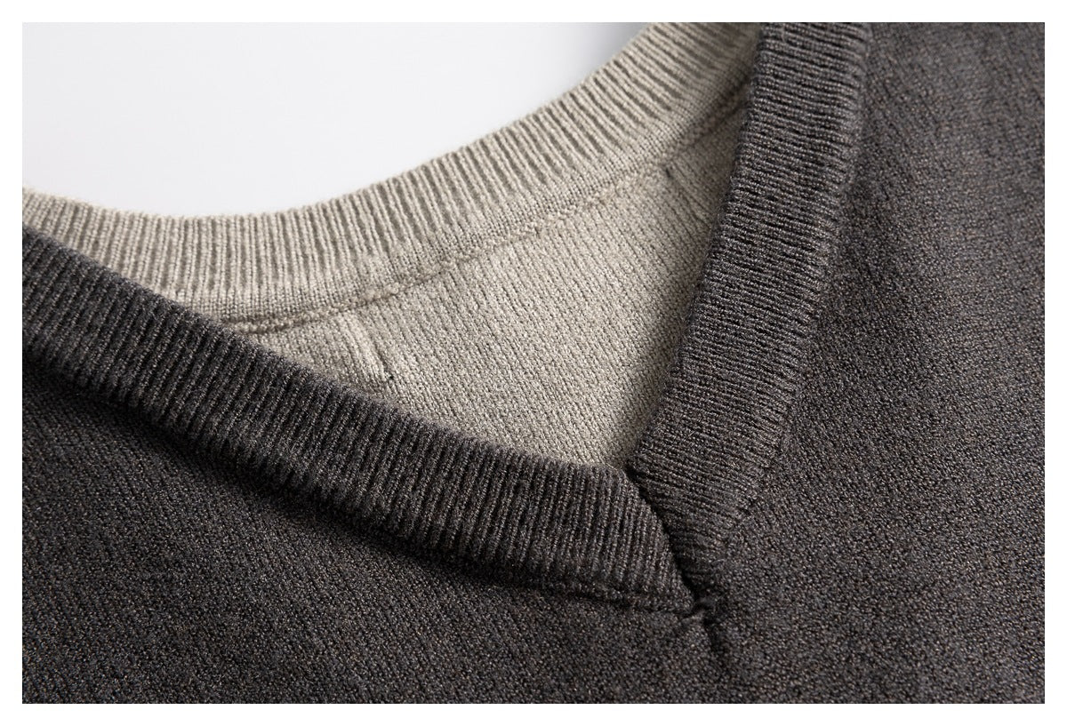 Close-up of the ribbed charcoal V-neck trim and light taupe crew neckline underneath.