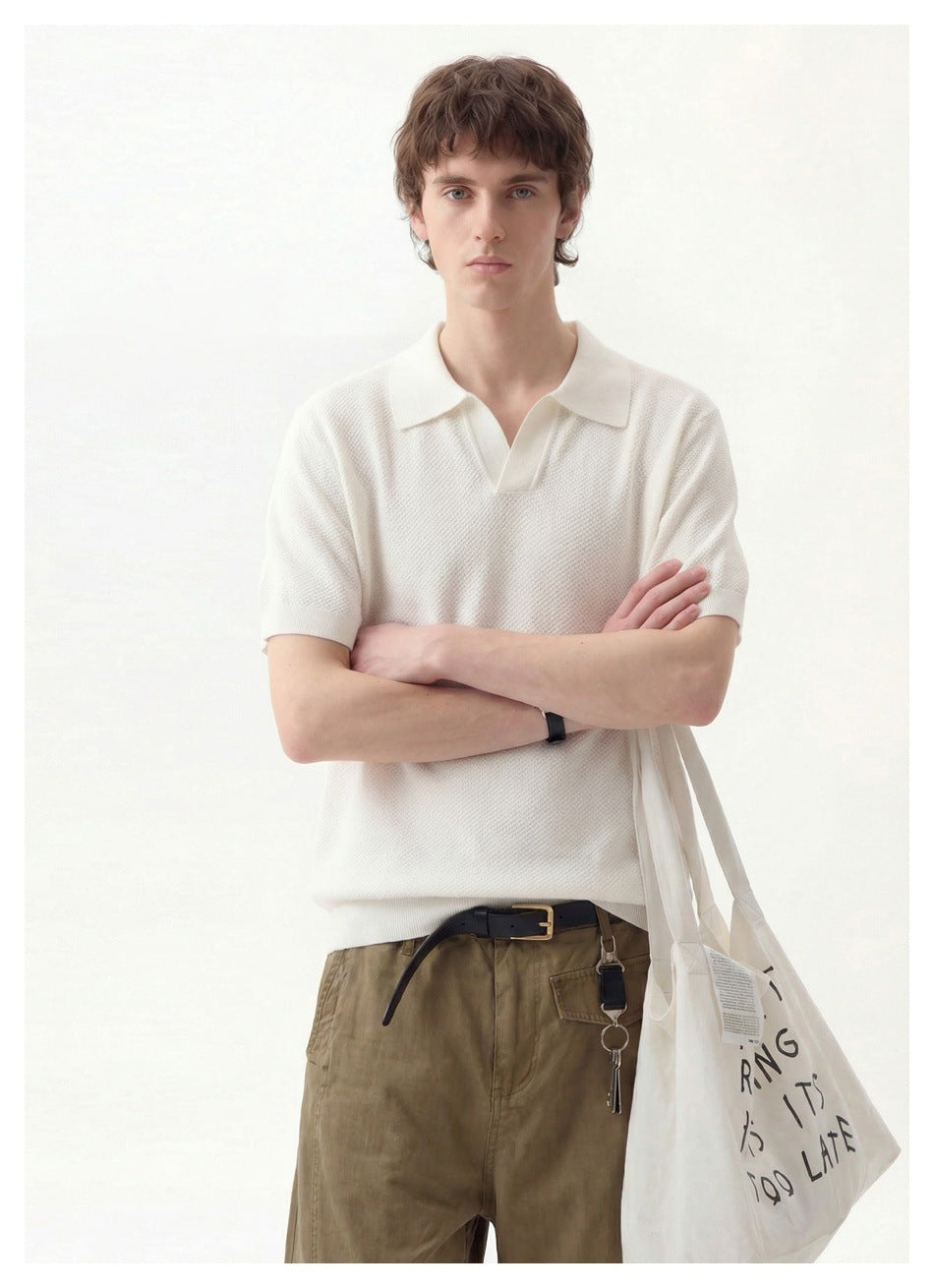 Man modeling an ivory textured short-sleeve polo with a collar and open neckline.