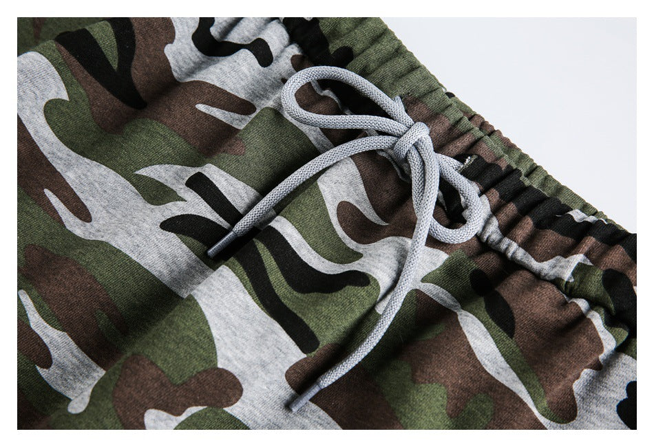 Close-up of the light gray drawstring tied at the elastic waistband against the camouflage print.