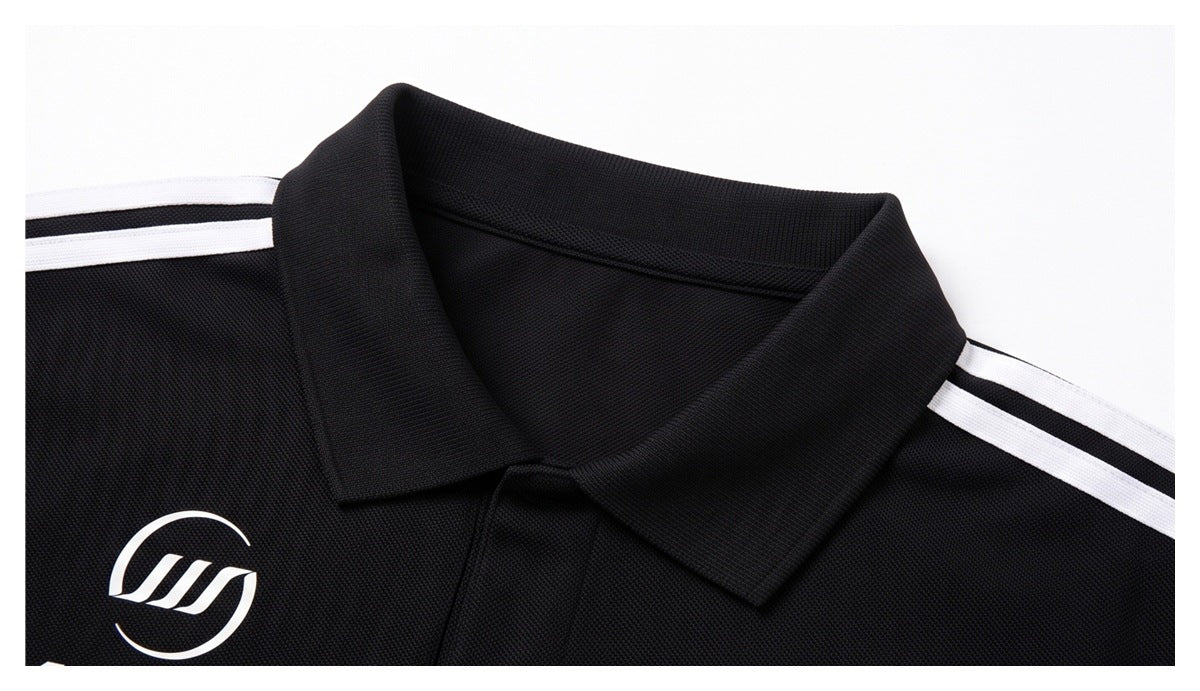 Close-up of the black polo collar and white shoulder stripes, with part of a white chest emblem visible.