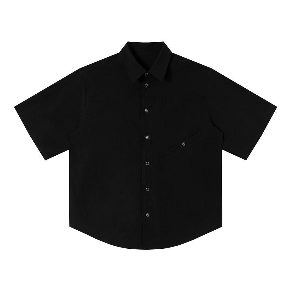 Black short-sleeve button-up shirt flat lay with point collar, dark metal buttons and diagonal chest pocket