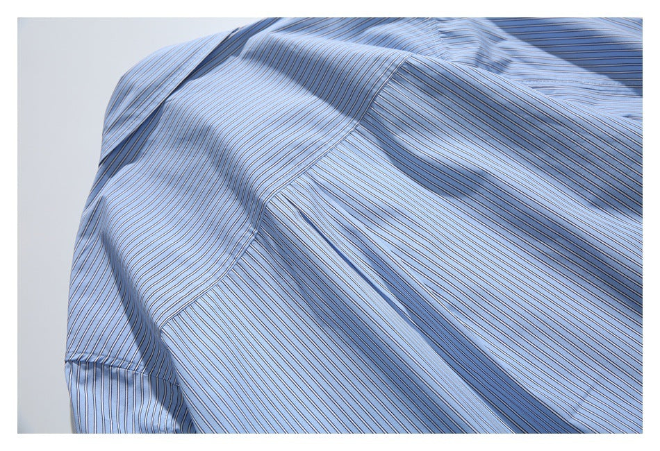 Close-up of striped shirt fabric and curved stitched panel seams.