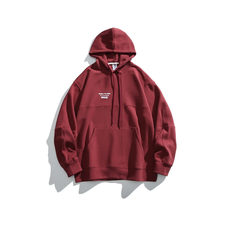 Red pullover hoodie flat lay with drawstring hood, kangaroo pocket, paneled seams and small chest print