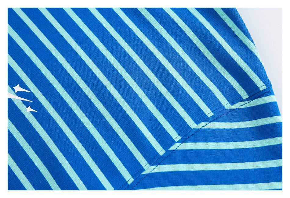 Close-up of the striped shirt's shoulder and sleeve seam, with part of a white graphic visible.