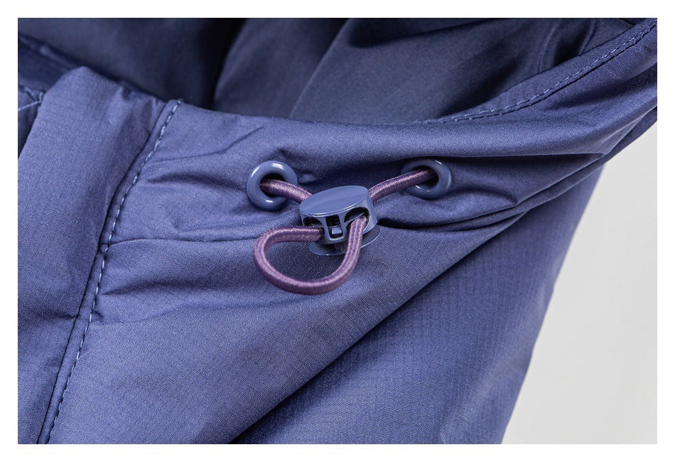 Close-up of a blue-purple jacket hood with a purple cord and plastic cord lock.