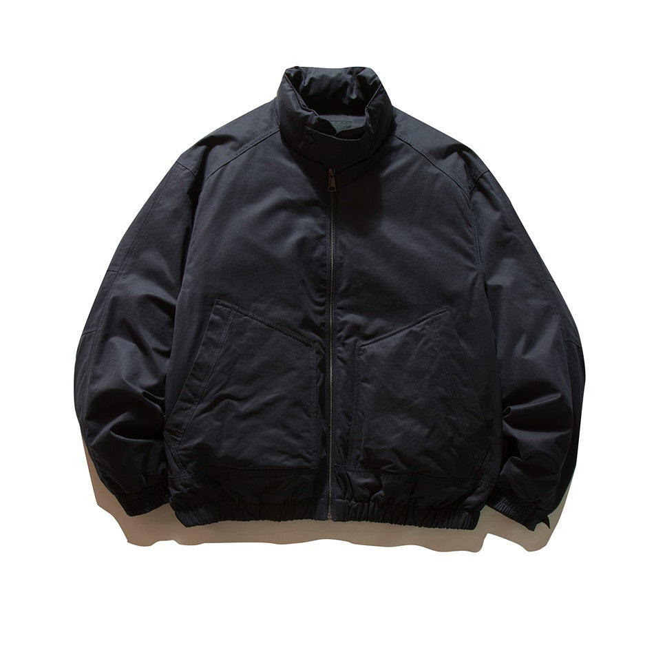 Navy stand-collar zip jacket with angled front pockets and elastic cuffs and hem, flat front view