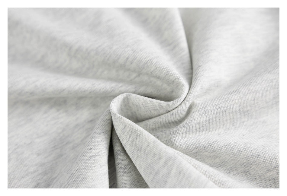 Close-up of light gray heather fabric gathered into a soft twist, showing its knit texture.