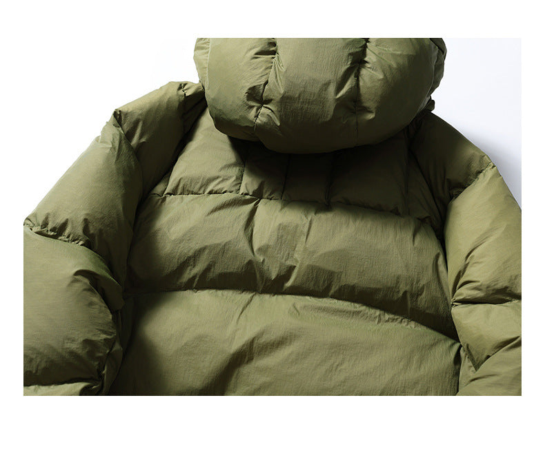 Close-up of the olive-green jacket's padded hood and upper back with broad stitched sections.