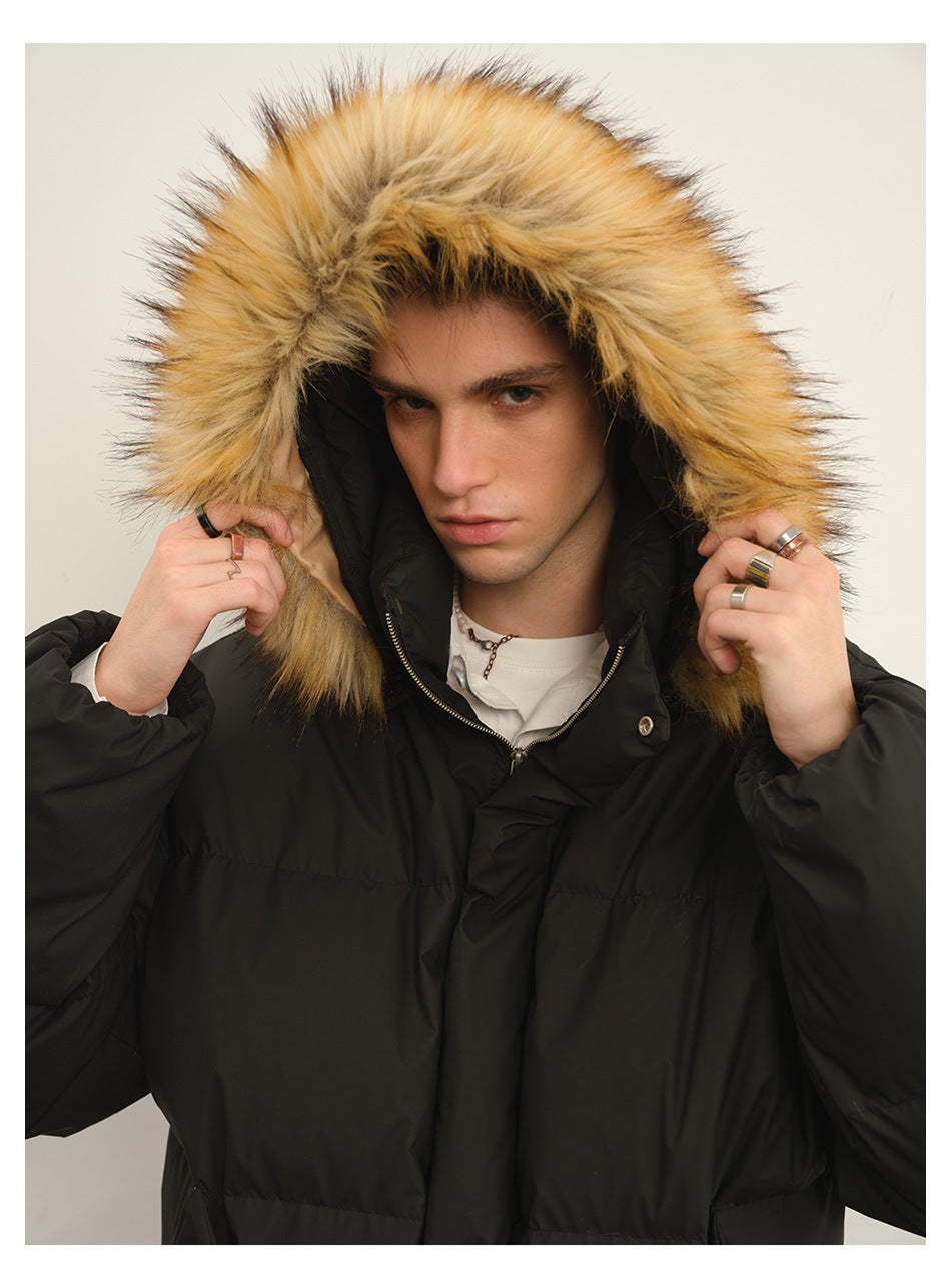 Close-up of a model wearing a black puffer jacket, highlighting its raised hood and thick tan fur trim.