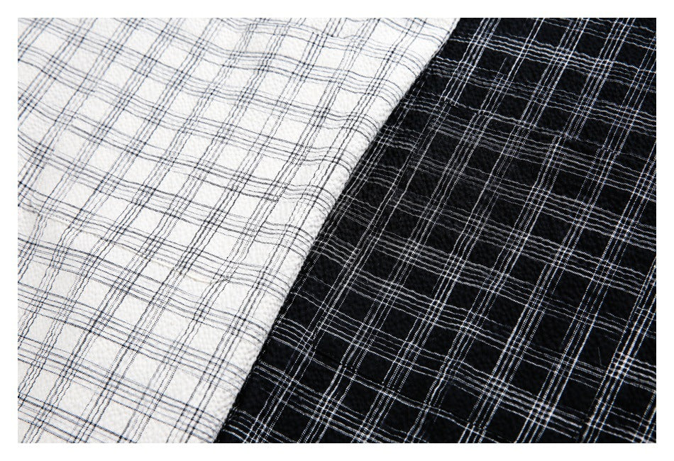 Close-up of ivory and black fabric with a fine plaid pattern.