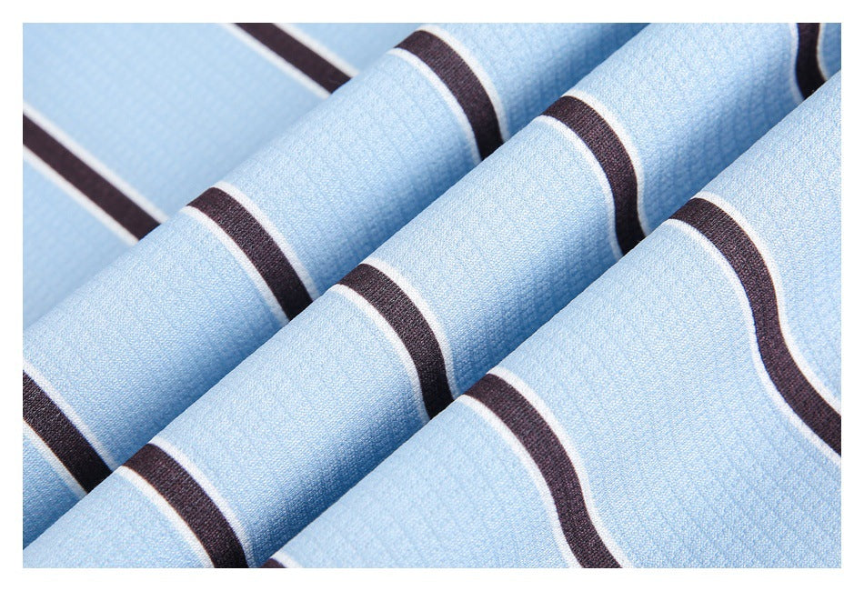 Close-up of pale blue textured striped fabric draped in folds, with dark brown and thin white bands.