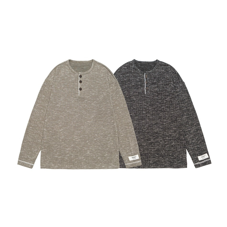 Two long-sleeve henleys shown flat in light beige and charcoal heather, each with a three-button placket.