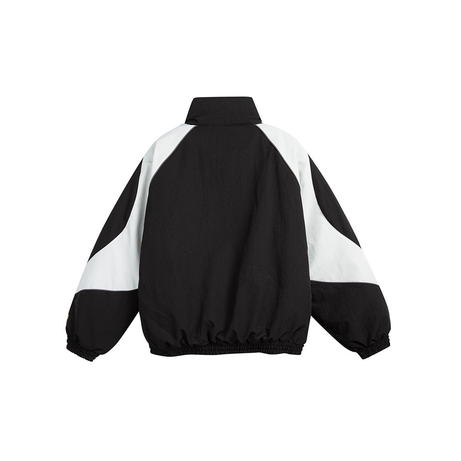 Back view of black stand-collar jacket with light gray raglan panels and elastic cuffs and hem