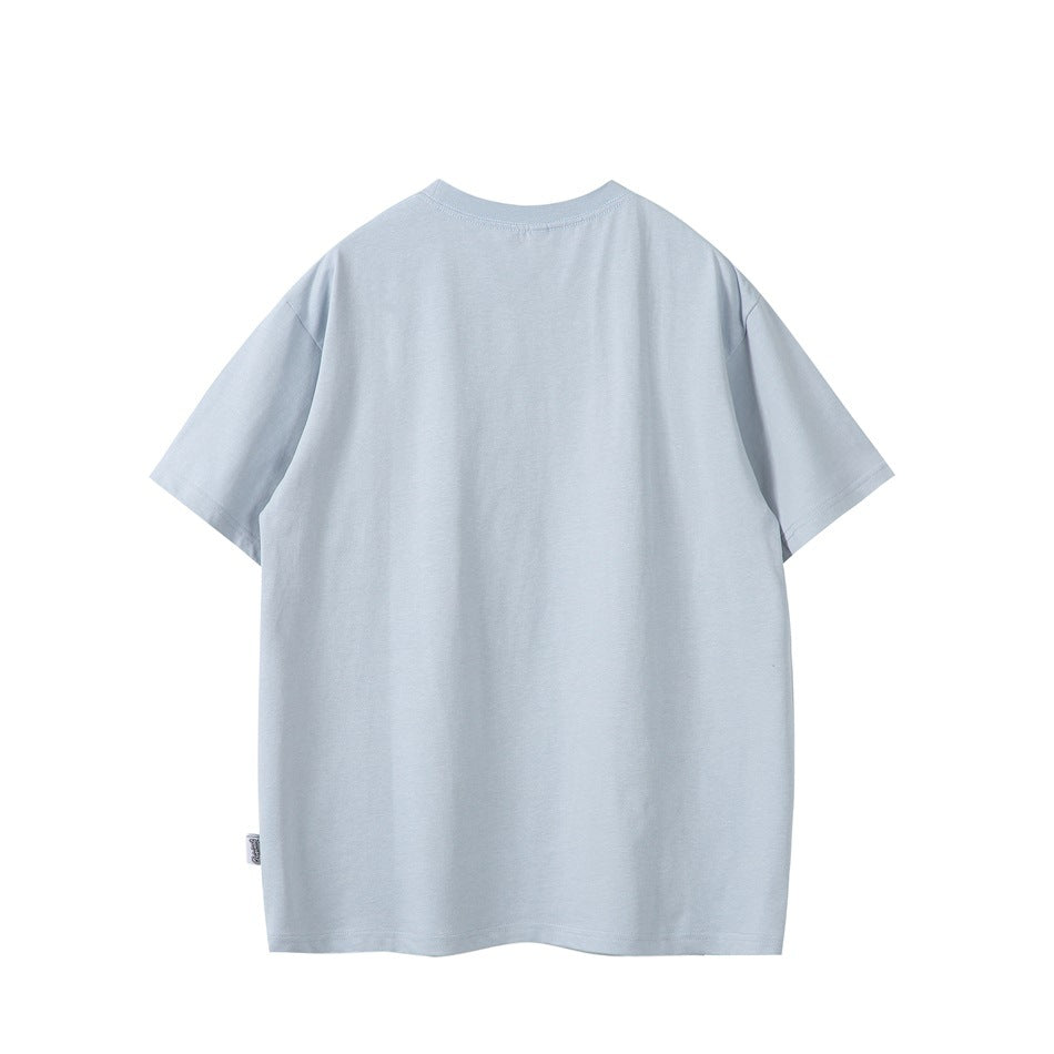 Back view of a plain light gray-blue short-sleeve crew neck T-shirt with a small side label, flat lay