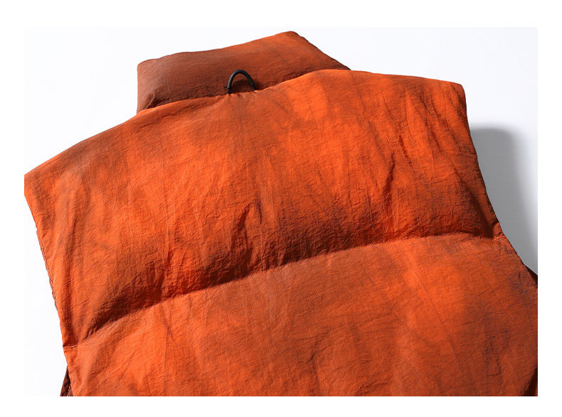 Close view of the rust-orange padded garment's back, with a small hanging loop at the neckline.