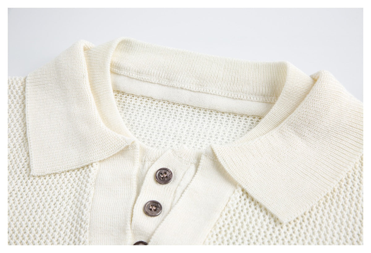Close-up of an ivory knit polo top's ribbed collar and button placket with dark buttons.