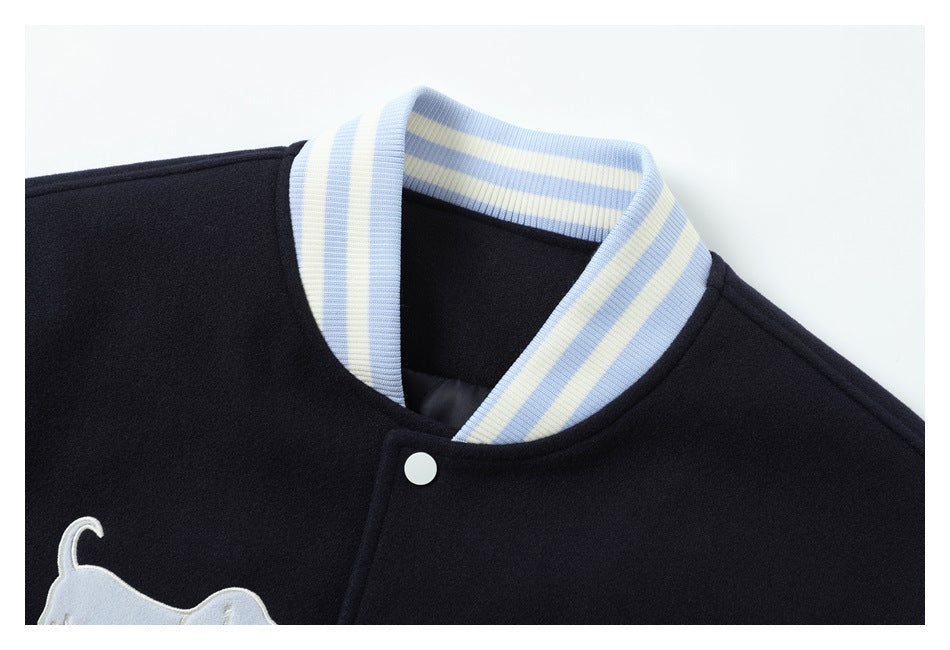 Close-up of the jacket's blue-and-cream striped ribbed collar, navy fabric and white snap button.