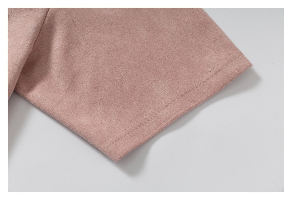 Close-up of the stitched sleeve hem on a dusty pink garment.